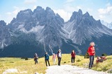 Hikers below rocky peaks