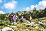 Group hiking through alpine rocks